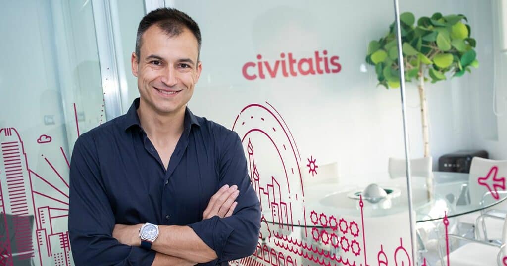 Smiling man in office with "Civitatis" logo, likely company executive after new investment announcement.